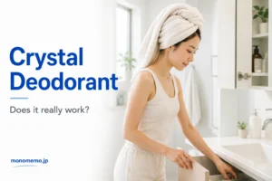 Woman with a towel wrapped around her hair opening a bathroom cabinet as part of a crystal deodorant routine