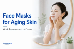 Woman wearing a hydrating sheet mask in front of a bathroom mirror as part of an aging skin care routine
