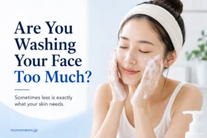 Featured image for a guide explaining the effects of washing your face too often, featuring a woman gently cleansing her face with a foaming cleanser in a clean, bright bathroom.